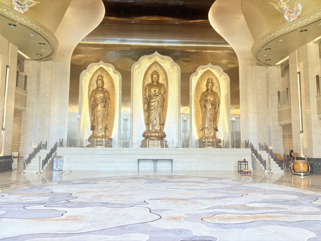 three tall standing buddha statues