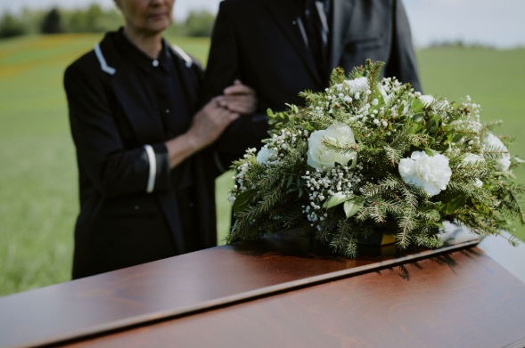 two people in black attending a funeral