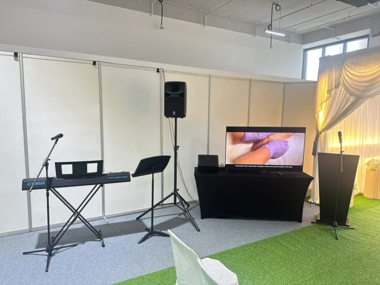 funeral service hall equipped with keyboard, microphones, audio speakers, podium, and display screen
